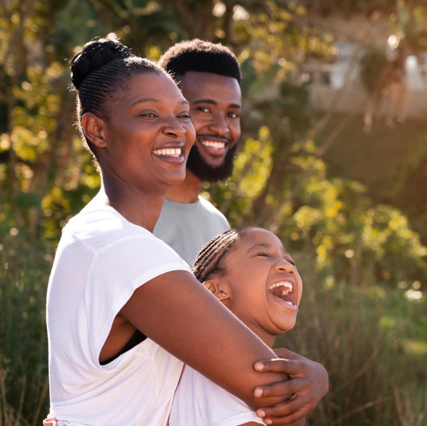 A family smiling together outdoors
