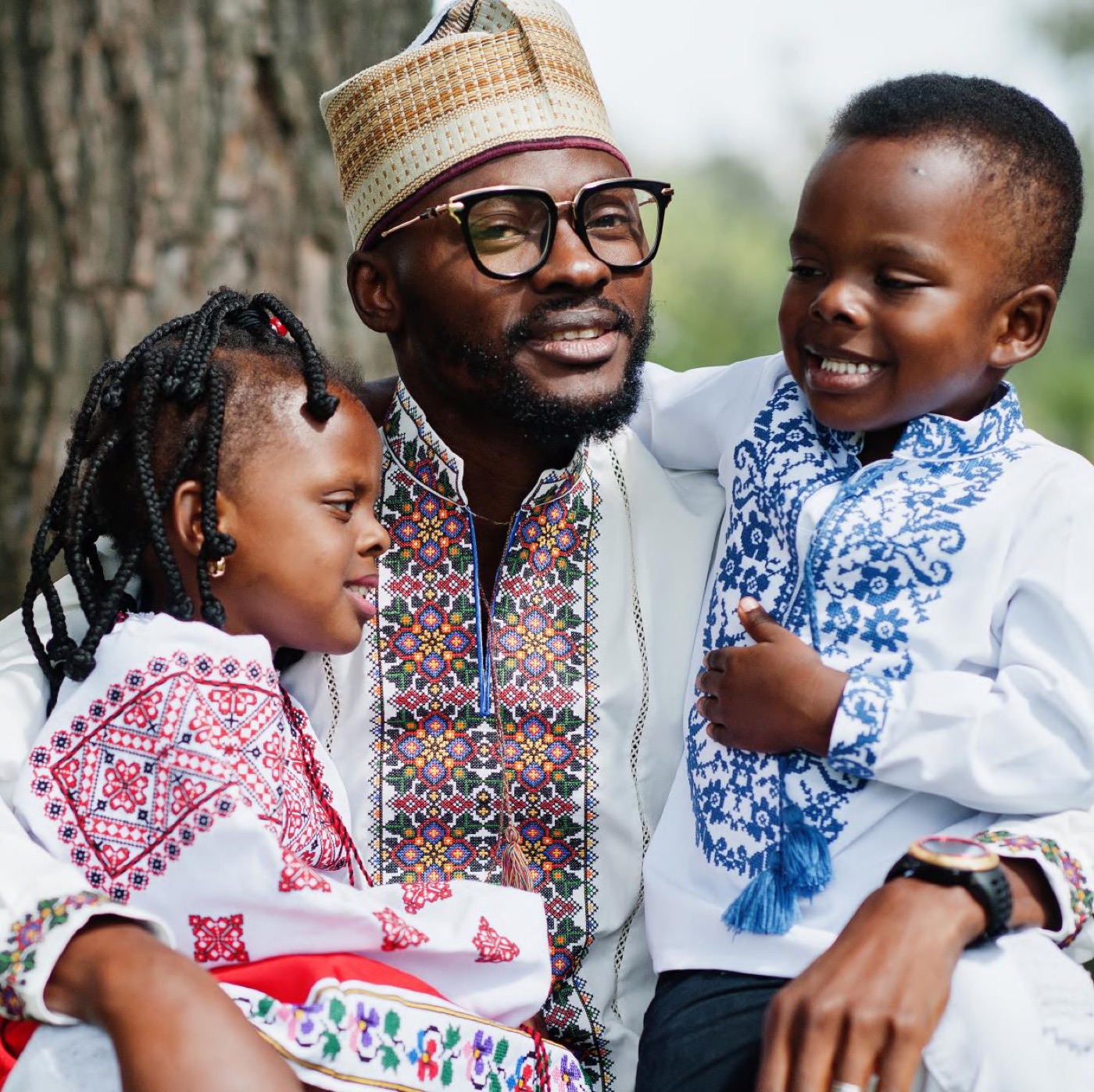 A parent sitting with two children